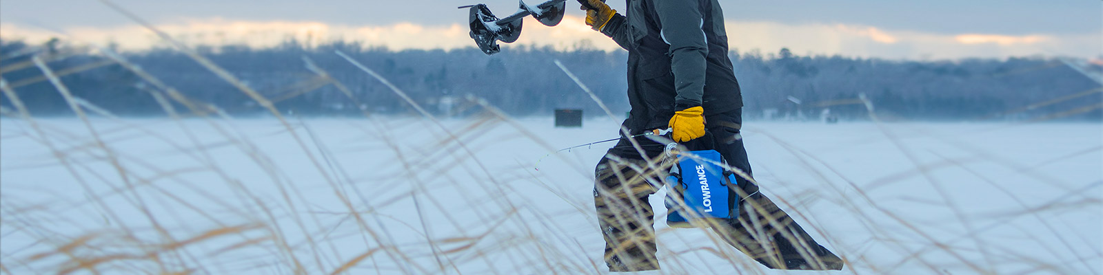 A man carrying his Lowrance ActiveTarget  Ice explorer Kit